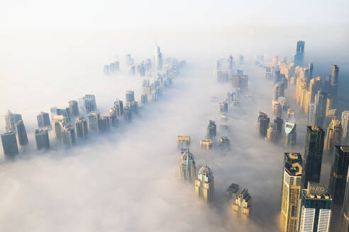 Aerial view of Dubai Marina with skyscrapers surrounded with fog, Dubai, United Arab Emirates. - AAEF27035