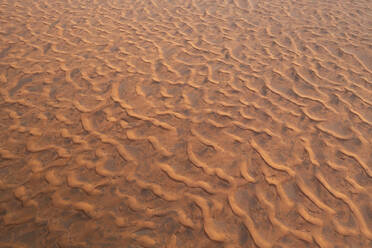 Aerial view of endless desert landscape with warm orange sand dunes, Sharjah, United Arab Emirates. - AAEF27040
