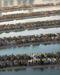 Aerial view of Dubai with geometric structures and luxurious homes on the exclusive Palm Jumeirah island, United Arab Emirates. - AAEF27041