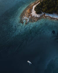 Aerial view of a sailboat along the coastline clear turquoise water and sandy coastline, Primorje-Gorski Kotar, Croatia. - AAEF27060