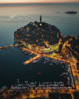 Aerial view of Rovinj's medieval town and harbor at dusk, Istria, Croatia. - AAEF27132