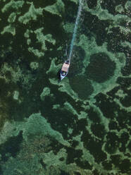 Aerial view of small fishing boat on crystal clear blue ocean, Pointe aux Canonniers, Grand Baie, Mauritius. - AAEF27166