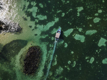 Aerial view of small fishing boat on crystal clear blue ocean, Pointe aux Canonniers, Grand Baie, Mauritius. - AAEF27167