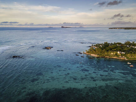 Aerial view of Pointe aux Canonniers coastline and clear Indian Ocean coastal reef at sunset, Grand Baie, Mauritius. - AAEF27174