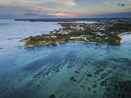 Aerial view of Pointe aux Canonniers coastline and clear Indian Ocean coastal reef at sunset, Grand Baie, Mauritius. - AAEF27178