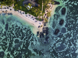 Aerial view of Pointe aux Canonniers coastline and clear Indian Ocean coastal reef at sunset, Grand Baie, Mauritius. - AAEF27179