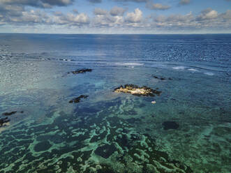 Aerial view of Pointe aux Canonniers coastline with boat and clear Indian Ocean coastal reef, Grand Baie, Mauritius. - AAEF27193