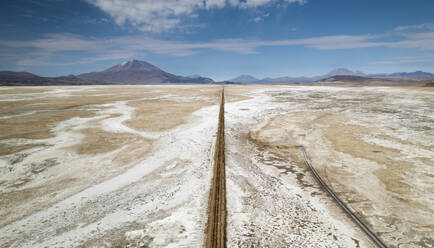 Aerial drone view of train tracks on Uyuni desert, the biggest salt desert in the world, Uyuni, Bolivia. - AAEF27219