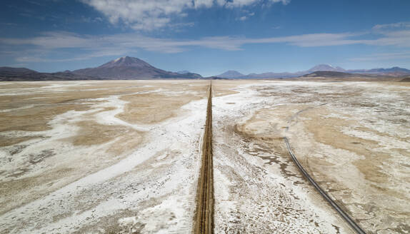 Aerial drone view of train tracks on Uyuni desert, the biggest salt desert in the world, Uyuni, Bolivia. - AAEF27219
