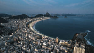 Aerial drone view of Copacabana Beach at night with the Surgarloaf in the back, Rio De Janeiro, Brazil. - AAEF27228