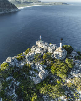 Aerial view of a person on Sentinel Peak along the Hout Bay, Cape Town, Western Cape, South Africa. - AAEF27302