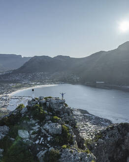 Aerial view of a person on Sentinel Peak along the Hout Bay, Cape Town, Western Cape, South Africa. - AAEF27306