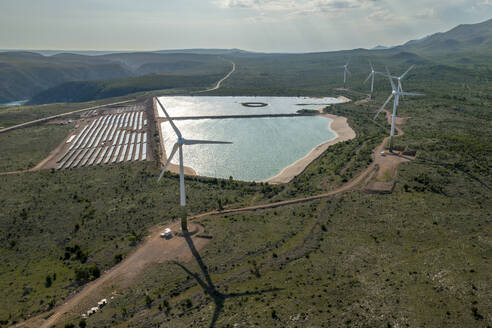 Aerial view of solar panel farm with reservoir and reflection in beautiful hills, Zadar, Croatia. - AAEF27476