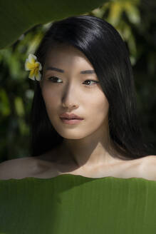 Beautiful young woman near banana leaves - EAF00140