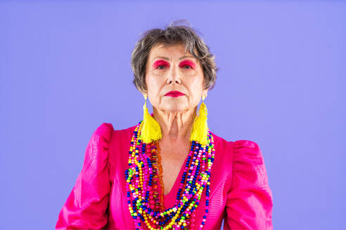 Happy and funny senior old woman wearing fashinable clothing on colorful background- Modern cool fancy grandmother portrait, concepts about elderly and older people - DMDF10658