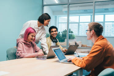 Cinematic image of a programming office with young programmers working on a new project for a start up business. - DMDF10810