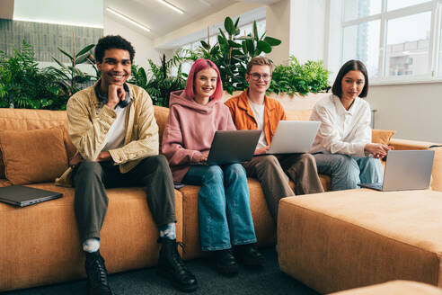 Cinematic image of a programming office with young programmers working on a new project for a start up business. - DMDF10813