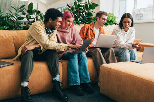 Cinematic image of a programming office with young programmers working on a new project for a start up business. - DMDF10814