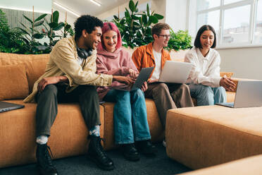 Cinematic image of a programming office with young programmers working on a new project for a start up business. - DMDF10815