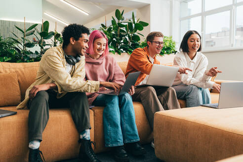 Cinematic image of a programming office with young programmers working on a new project for a start up business. - DMDF10816