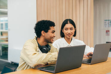 Cinematic image of a programming office with young programmers working on a new project for a start up business. - DMDF10831