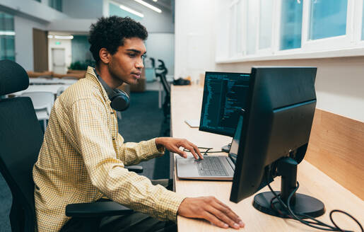 Cinematic image of a programming office with young programmers working on a new project for a start up business. - DMDF10847