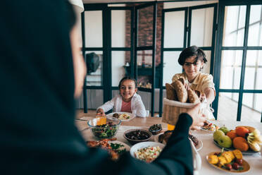 Traditional arabian family from Dubai spending time together at home. Concept about, emirati culture, parenthood, adoption and family lifestyle - DMDF10975