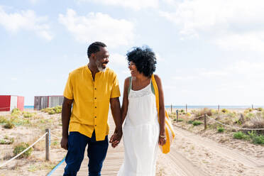 Beautiful mature black couple of lovers dating at the seaside - Married african middle-aged couple bonding and having fun outdoors, concepts about relationship, lifestyle and quality of life - DMDF11021