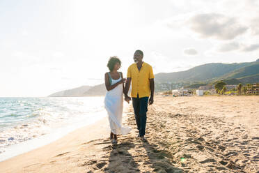 Beautiful mature black couple of lovers dating at the seaside - Married african middle-aged couple bonding and having fun outdoors, concepts about relationship, lifestyle and quality of life - DMDF11076