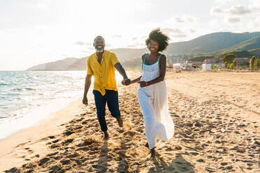 Beautiful mature black couple of lovers dating at the seaside - Married african middle-aged couple bonding and having fun outdoors, concepts about relationship, lifestyle and quality of life - DMDF11095