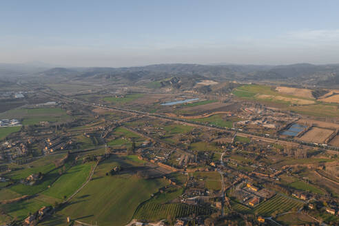 Aerial view of the highway crossing the valley with hills at sunset near Orvieto, Umbria, Terni, Italy. - AAEF27555