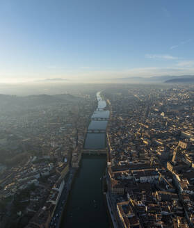 Aerial panoramic view of Ponte Vecchio crossing the Arno river in Florence downtown at sunset, Florence, Tuscany, Italy. - AAEF27584