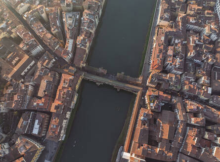 Aerial view of Ponte Vecchio crossing the Arno river in Florence downtown at sunset, Florence, Tuscany, Italy. - AAEF27586