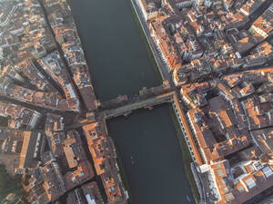 Aerial view of Ponte Vecchio crossing the Arno river in Florence downtown at sunset, Florence, Tuscany, Italy. - AAEF27587