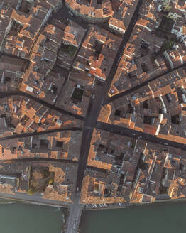 Aerial top down view of rooftops in Florence old town along the Arno river, Florence, Tuscany, Italy. - AAEF27594