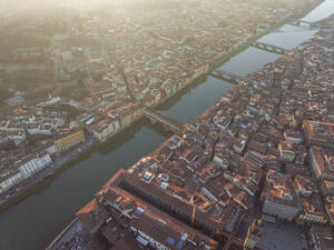 Aerial view of Ponte Vecchio crossing the Arno river in Florence downtown at sunset, Florence, Tuscany, Italy. - AAEF27612