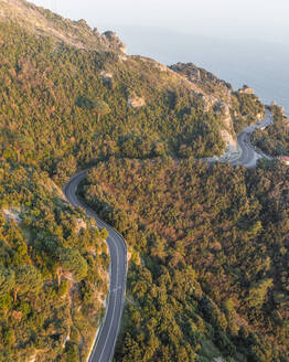 Aerial view of the road along the Amalfi Coast at sunset, Amalfi, Salerno, Campania, Italy. - AAEF27667