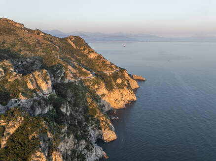 Aerial view of the scenic road along the Amalfi Coast facing the Mediterranean Sea at sunset, Amalfi, Salerno, Campania, Italy. - AAEF27671