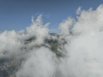 Aerial view of low clouds on the mountain peak in Capaccio near Paestum, Salerno, Campania, italy. - AAEF27694