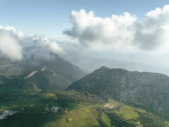 Aerial view of Trentinara, a small town on the mountain peak with low clouds, Salerno, Campania, italy. - AAEF27696