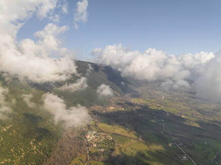 Aerial view of the countryside with residential houses in Capaccio, a small town along the mountains with low clouds, Paestum, Salerno, Campania, italy. - AAEF27699