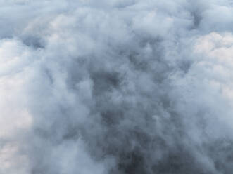 Aerial top down view of thick low clouds fog as seen fromn the plane, Salerno, Campania, Italy. - AAEF27707