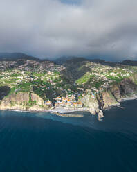 Aerial drone view of Ponta do Sol town during sunset, at the south coast of Madeira island, Portugal. - AAEF27718