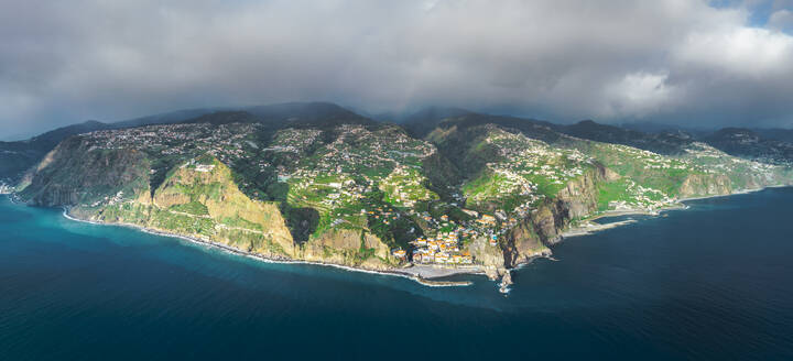 Aerial drone view of Ponta do Sol town during sunset, at the south coast of Madeira island, Portugal. - AAEF27719