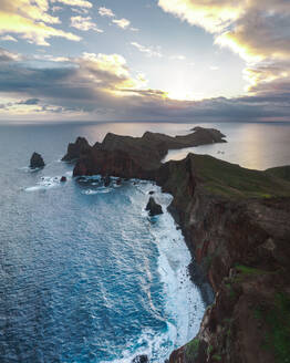 Aerial drone view of Ponta do Castelo during sunrise, Eastern Peninsula of Madeira island, Portugal. - AAEF27726