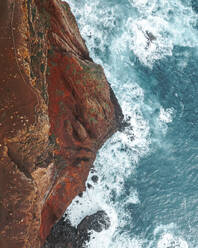 Aerial drone top-down view of Ponta do Castelo cliffs during sunrise, Eastern Peninsula of Madeira island, Portugal. - AAEF27727