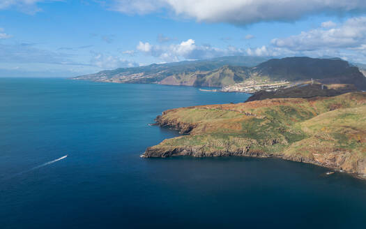 Aerial drone view of the Eastern Peninsula coastline with a boat, Madeira island, Portugal. - AAEF27731