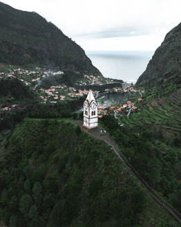 Aerial drone view of Capelinha de Nossa Senhora de Fatima white church, Sao Vicente, Madeira island, Portugal. - AAEF27732