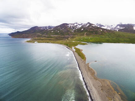 Aerial view of coast with sea, lagoon Miklavatn and snow-capped mountains in Skagafjordur, Nordurland vestra, Iceland. - AAEF27818