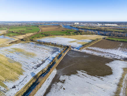 Aerial view of frozen floodplains with snow after high water in river Maas, Maasheggen, Beugen, Noord-Brabant, Netherlands. - AAEF27842